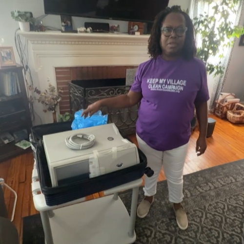 A picture of Martishia Young standing in her living room.