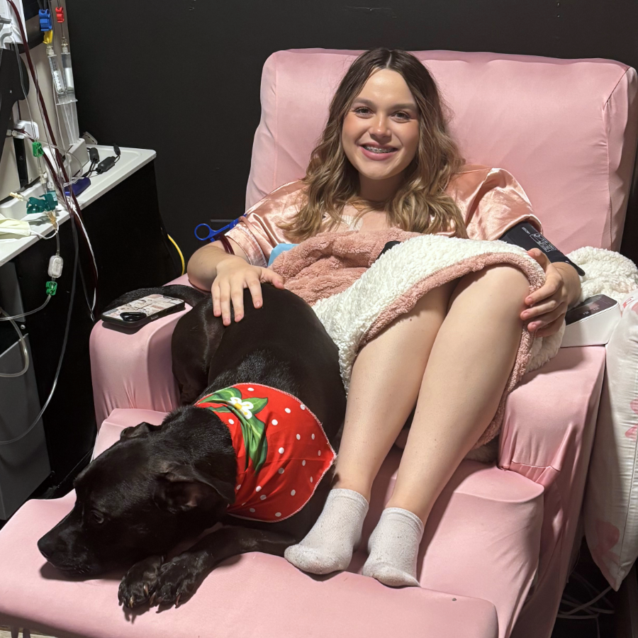 Llana Wright, a 20 year old young woman seeking a kidney donor, sitting in a chair with her dog.